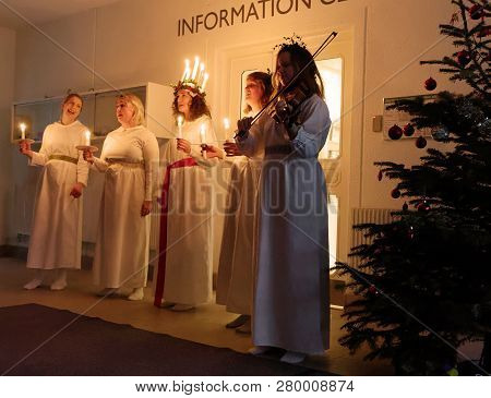 Stockholm, Sweden - Dec 13, 2018: Lucia Parade With Singing Girls In White Dresses Holding Candles. 
