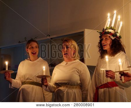 Stockholm, Sweden - Dec 13, 2018: Lucia Parade With Singing Girls In White Dresses Holding Candles. 