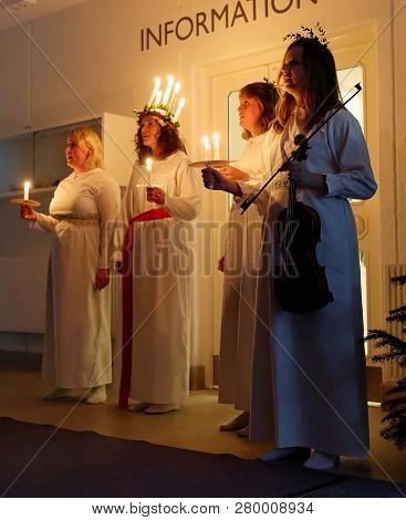 Stockholm, Sweden - Dec 13, 2018: Lucia Parade With Singing Girls In White Dresses Holding Candles. 