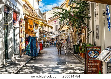 Athens, Greece - September 22 2018: Tourists Walk The Streets Lined With Souvenir  And Gift Shops An