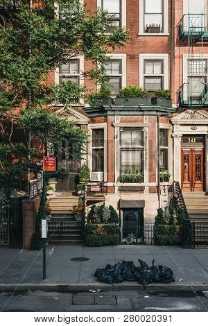 New York, Usa - May 30, 2018: Facade Of A Typical New York House With A Stoop, Rubbish In Black Bins
