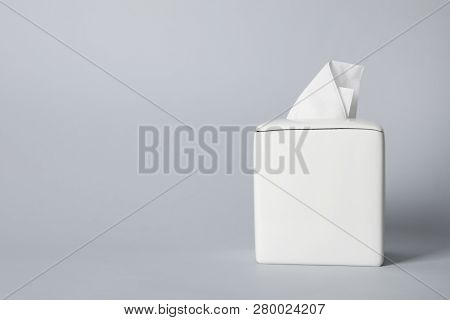 Napkin Holder With Paper Serviettes On Gray Background. Space For Text