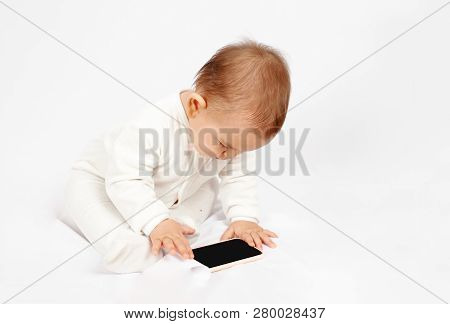 Baby Holding A Mobile Phone Isolated On White Background