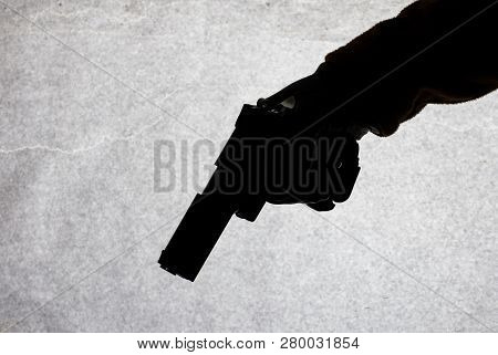 The Gun In The Hand Of Men Who Is Ready To Shoot At His Victim. Breaking The Law And Crime. Attack W