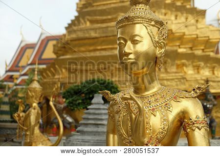 Golden Kinnari Statue At Temple Of Emerald Buddha (wat Phra Kaew) In Grand Royal Palace. Half-bird,