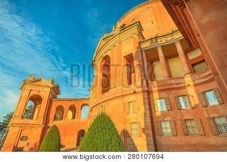 Side View Of Bell Tower At Sanctuary Of Madonna Di San Luca With Arcades Of Its Long Portico. The Ch