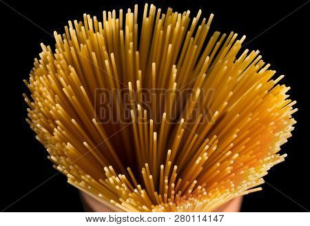 Yellow Long Spaghetti On A Black Background. Yellow Italian Pasta. Flower Of Whole Wheat Spaghetti G