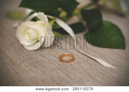 Wedding Ring And Cream Rose. Wedding Symbols, Attributes. Holiday, Celebration. Macro. Blur.