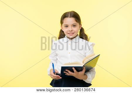 Child Girl School Uniform Clothes Hold Book And Pen. Girl Cute Write Down Idea Notes. Notes To Remem