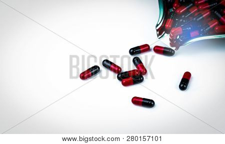 Red-black Capsule Pill On Drug Tray. Medicine For Treatment And Prevention Migraine Headache. Pharma