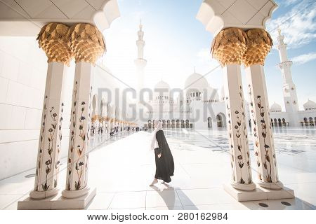 Traditionally Dressed Arabic Woman Wearing Black Burka Wisiting Sheikh Zayed Grand Mosque In Abu Dha