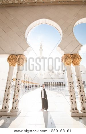 Traditionally Dressed Arabic Woman Wearing Black Burka Wisiting Sheikh Zayed Grand Mosque In Abu Dha