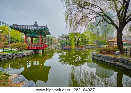 Yeouido Park public park pond with pavilion summerhouse in Seoul, Korea