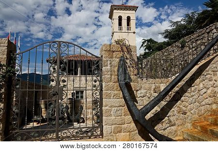 Old Bell Tower And The Old Anchor In Herceg Novi. Herceg Novi Is One Of The Most Beautiful Cities In