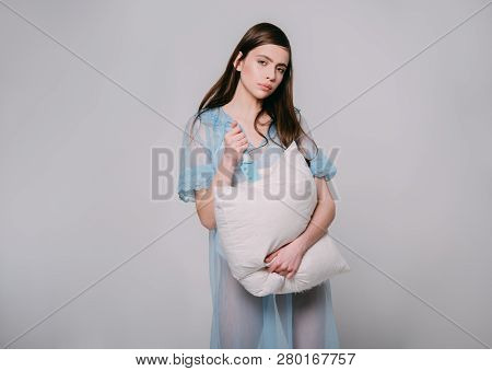 Beautiful Cruelty. Cute Girl Cuts Pillow With Knife In Nightie Lingerie. Pretty Girl In Sleep Shirt 