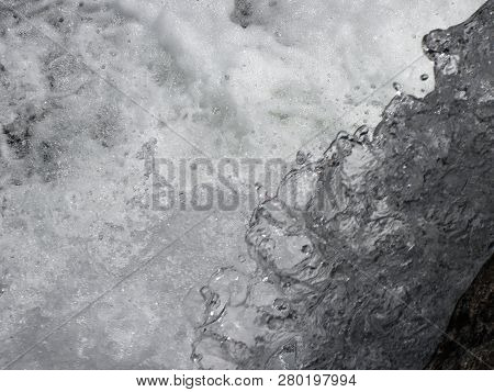 Water Flowing And Splashing Over Rocks Background