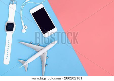 Hi Tech Travel Gadget And Accessories On Blue Pink Copy Space Flat Lay Top View