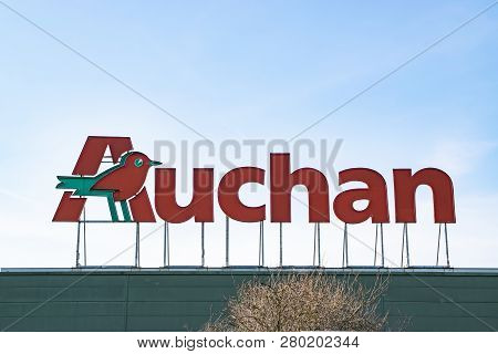 Roncq,france-february 25,2018: View Of Auchan Supermarket Logo, Entrance And Parking.auchan Is A Fre