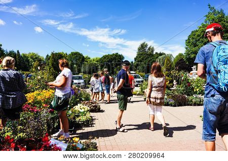 Dobrzyca, Poland - August 6, 2018: People Looking At Flowers For Sale At The Hortulus Park.