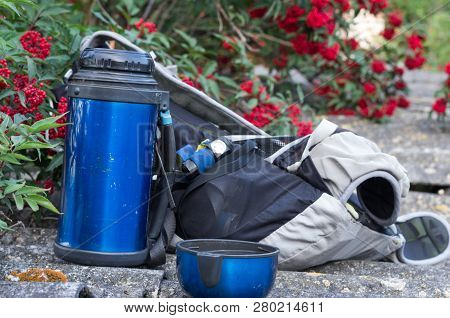 Thermos, Backpack And Headlamp. Tourist Equipment. Cup With A Drink.