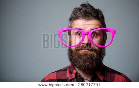 Nerd Concept. Hipster Looking Through Of Giant Pink Eyeglasses. Man Beard And Mustache Face Wear Fun