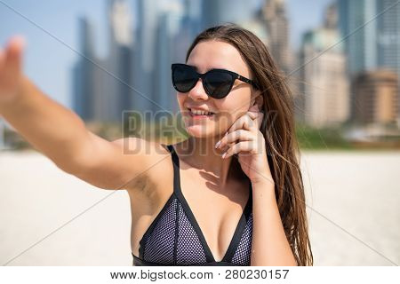 Pretty Young Woman In Swimsuit Taking Selfie On The Jbr Beach In Dubai. Pretty Young Female Tourist 