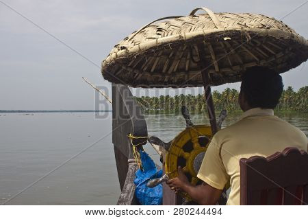 Backwaters, India - August 24: Man Driving A Houseboat On August 24, 2011 In Backwaters, India. Back