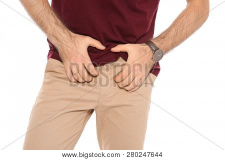 Man Scratching Crotch On White Background, Closeup. Annoying Itch