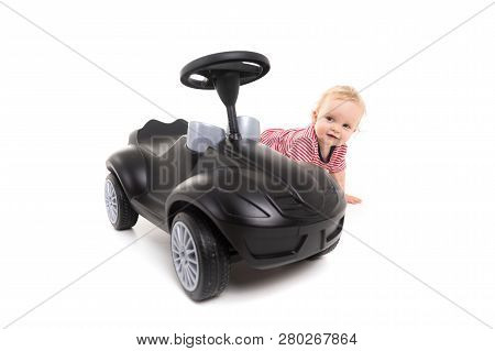 Baby Next To Black Toy Car Isolated On White Background