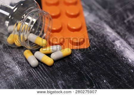Pills In Capsules And Blister Pack On Dark Wooden Table, Medication Close-up. Concept Of Pharmacy, F