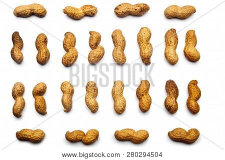 A Collection Of  Unpeeled Peanuts Lie In Horizontal Rows On An Isolated White Background. With Clipp
