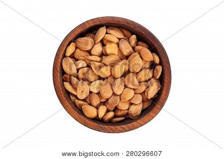 Unpeeled Apricot Stone In A Wooden Cedar Plate On A White Isolated Background. Row Of Bowls With Apr