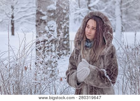 Young Woman In Winter Forest, Snowinf And Cold Winter, Girl In Fur Coat, Warm Clotes