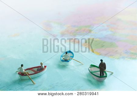 Miniature People Inside Sail Boats On A World Map