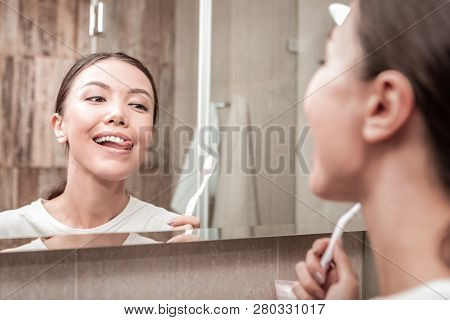 Young Appealing Woman Looking At Her Nice White Teeth
