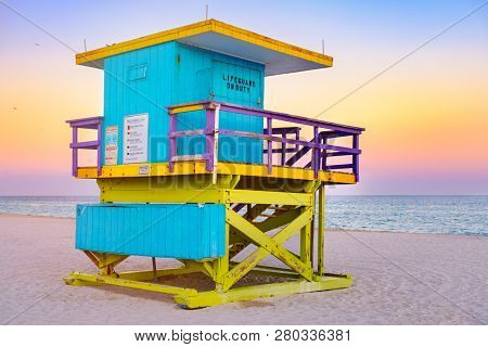 Famous lifeguard tower at South Beach in Miami with a beautiful sunset sky