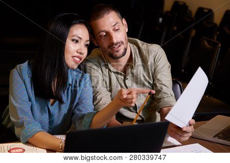 Positive Business People Discussing Informatio In Document At Daily Meeting