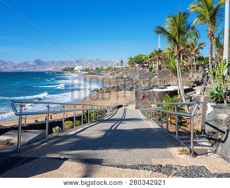 Puerto Del Carmen Beach In Lanzarote, Canary Islands, Spain. Blue Sea, Palm Trees, Selective Focus