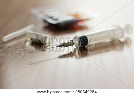 Injection Syringe And Ampoules On The Table
