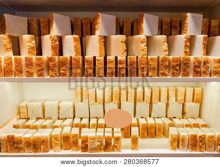 Bars Of Soap On A Shop Window. Turmeric Soap With Natural Cedar Oil And Herbal Ingredients. Handmade
