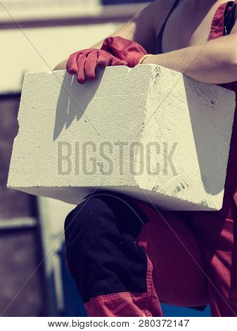 Unrecognizable Woman Working On Construction Site, Building House, Installing Gray Airbricks. Indust