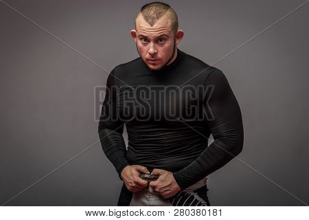 Beefy Male Fighter On The Grey Background.
