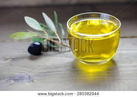 Olive Oil And Olive Branch On The Wooden Table, Italian Food, Mediterranean Diet