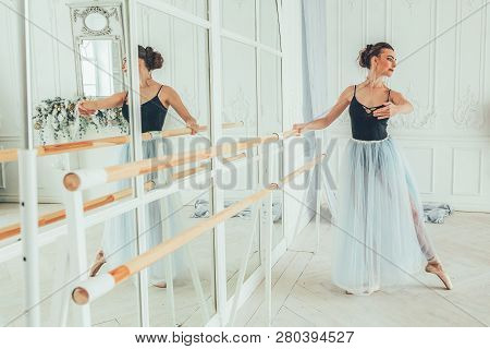 Young Classical Ballet Dancer Woman In Dance Class. Beautiful Graceful Ballerina Practice Ballet Pos