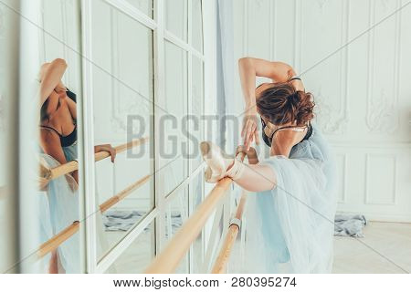Young Classical Ballet Dancer Woman In Dance Class. Beautiful Graceful Ballerina Practice Ballet Pos