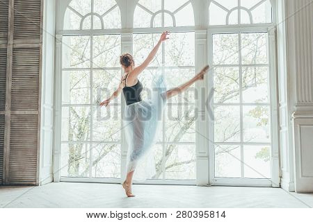 Young Classical Ballet Dancer Woman In Dance Class. Beautiful Graceful Ballerina Practice Ballet Pos