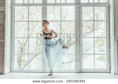 Young Classical Ballet Dancer Woman In Dance Class. Beautiful Graceful Ballerina Practice Ballet Pos