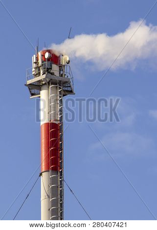 Smoke From Industrial Chimneys Against The Blue Sky. Pollution.