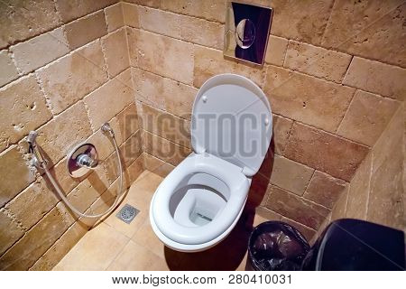 Toilet Seat Decoration In Bathroom Interior - Vintage Light Filter . White Flush Toilet And Dirty Ar