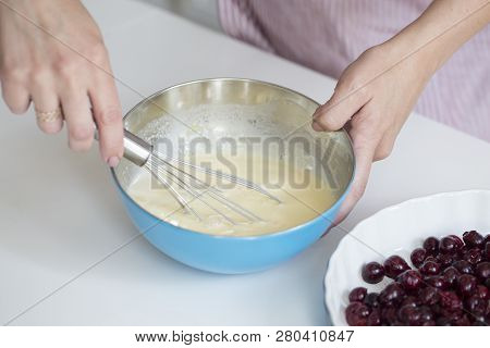 Young Woman Cooking In Kitchen.clafoutis Cherry Pie. Preparation Of A French Pie With Cherries